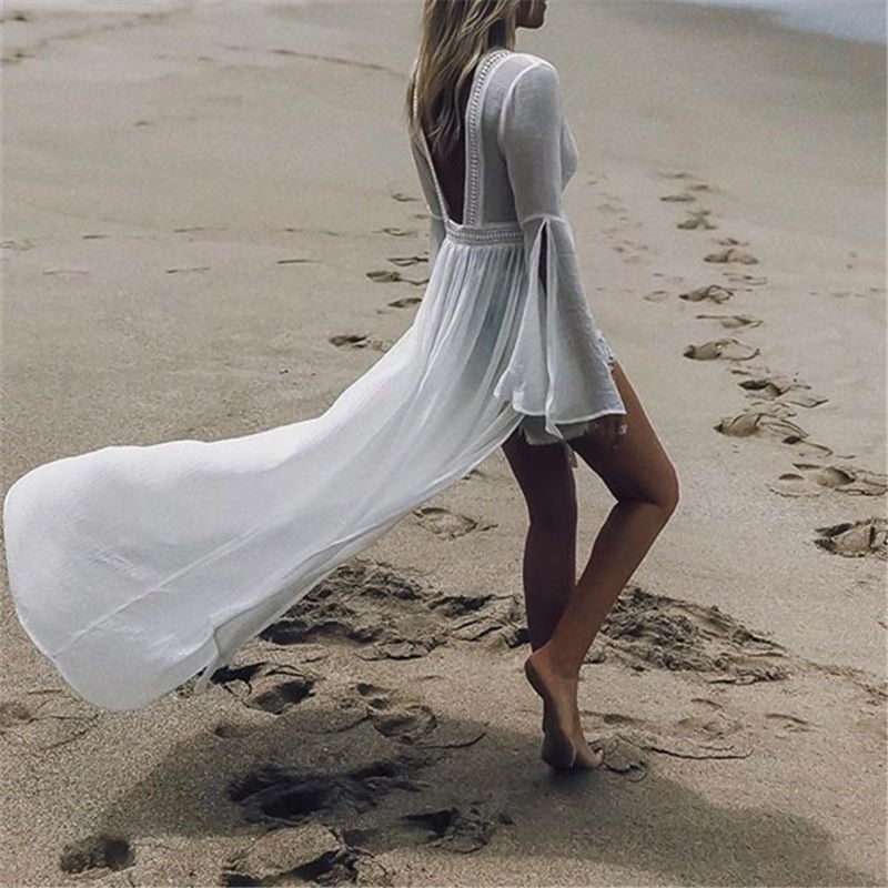 Elegant white maxi beach dress with an open back, flattering flare sleeves, and a flowy silhouette for summer.
