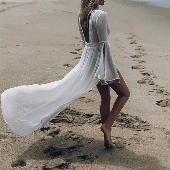Elegant white maxi beach dress with an open back, flattering flare sleeves, and a flowy silhouette for summer.