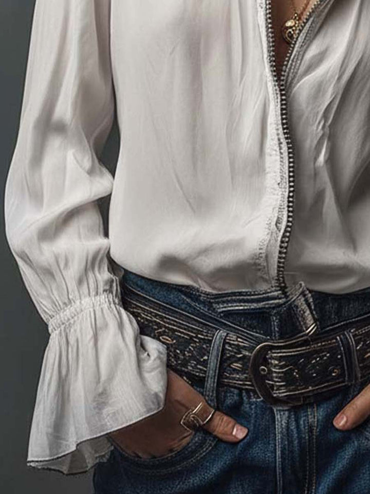 Tailored white blouse for women, designed with a practical zip front and trendy bell cuffs. Fashion-forward office wear.