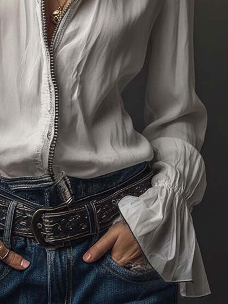 Fashionable white women's blouse featuring a unique zip front and stylish bell cuffs. Great for many occasions.