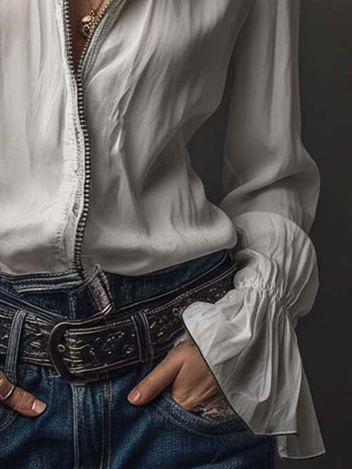 Fashionable white women's blouse featuring a unique zip front and stylish bell cuffs. Great for many occasions.