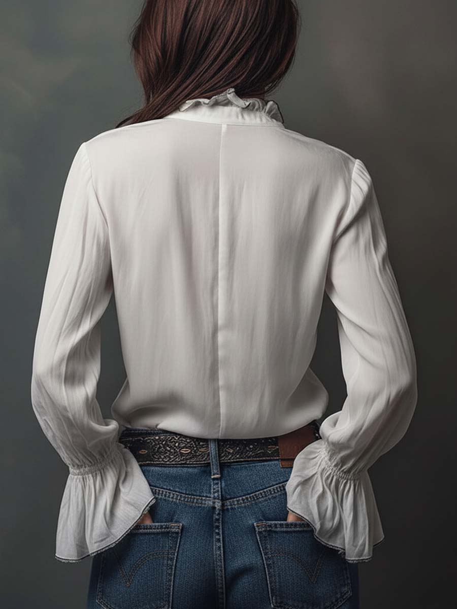 Sophisticated women's white blouse with a convenient zip front and eye-catching bell cuffs. Elevates any outfit.