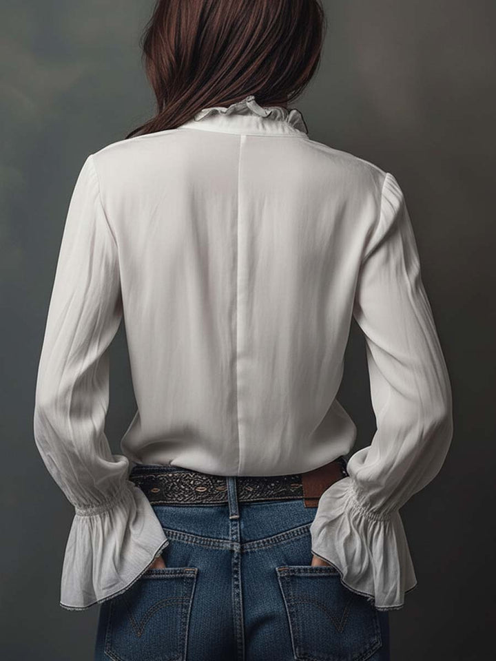 Sophisticated women's white blouse with a convenient zip front and eye-catching bell cuffs. Elevates any outfit.