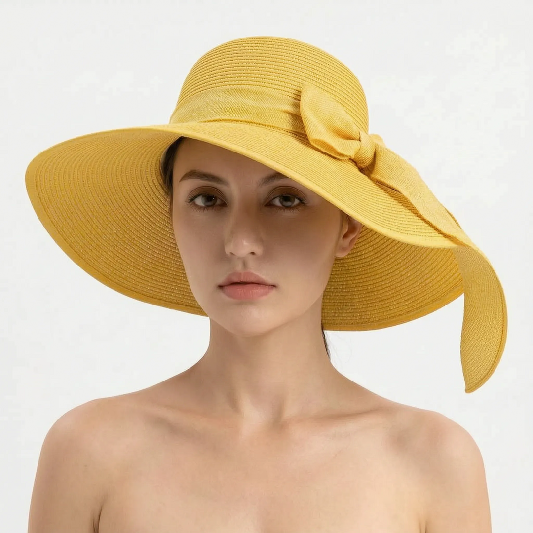 Women's wide brim beach sun hat, foldable and chic for seaside vacations & UV protection.