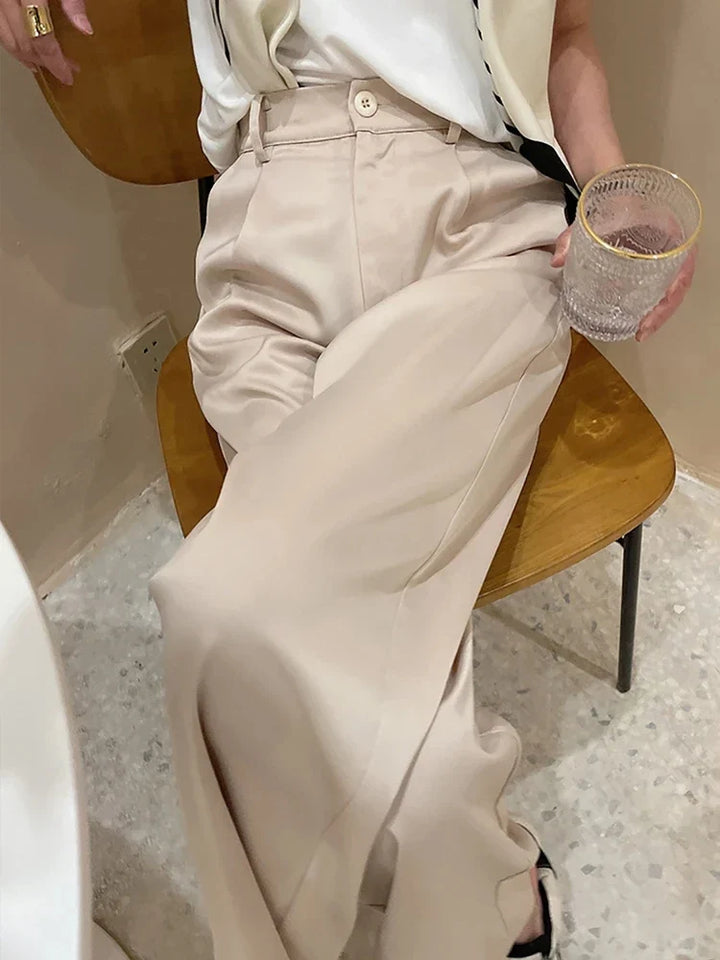 Fashionable women's wide leg pants with a high waist, loose fit, and elegant style.