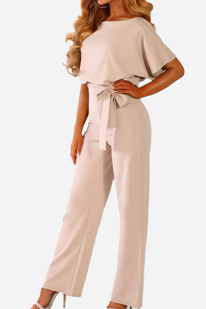 Chic women's wide-leg jumpsuit featuring batwing sleeves & a belted waist. Perfect day-to-night outfit.