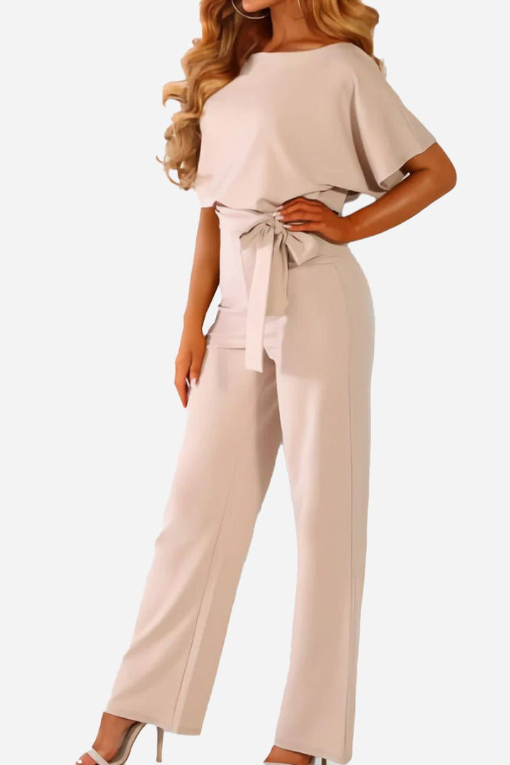 Chic women's wide-leg jumpsuit featuring batwing sleeves & a belted waist. Perfect day-to-night outfit.