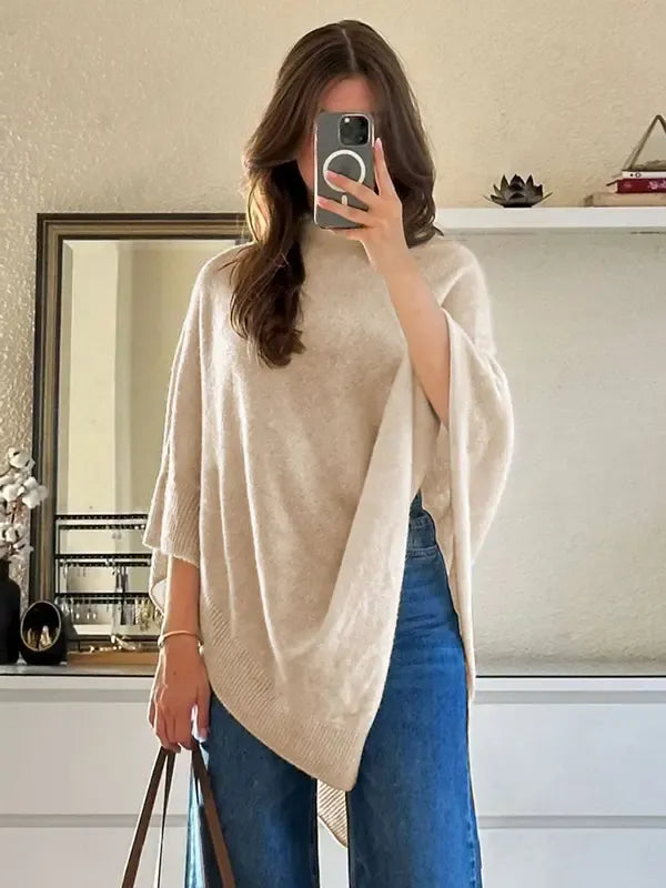 Stylish women's knitwear poncho with an asymmetric hem, made from a cozy wool-blend, ideal for fall fashion