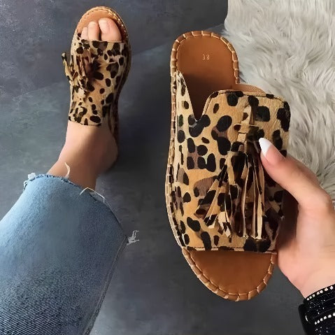 Comfortable women's slip-on sandals with a stylish woven strap and cushioned footbed, perfect for beach or casual outfits.