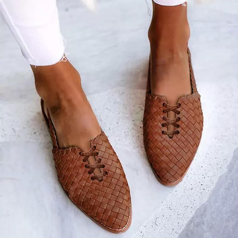 Fashionable women's woven pointed toe flat loafers. Comfortable slip-on design for a chic, dressy casual look.