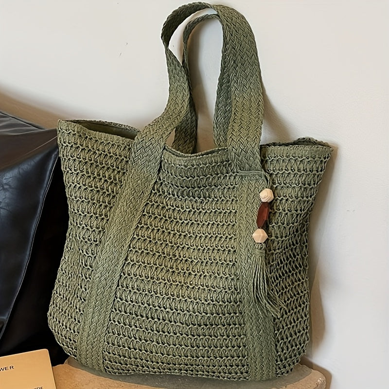 Elegant women's shoulder bag: natural woven straw tote with decorative fringe & a chic tassel.