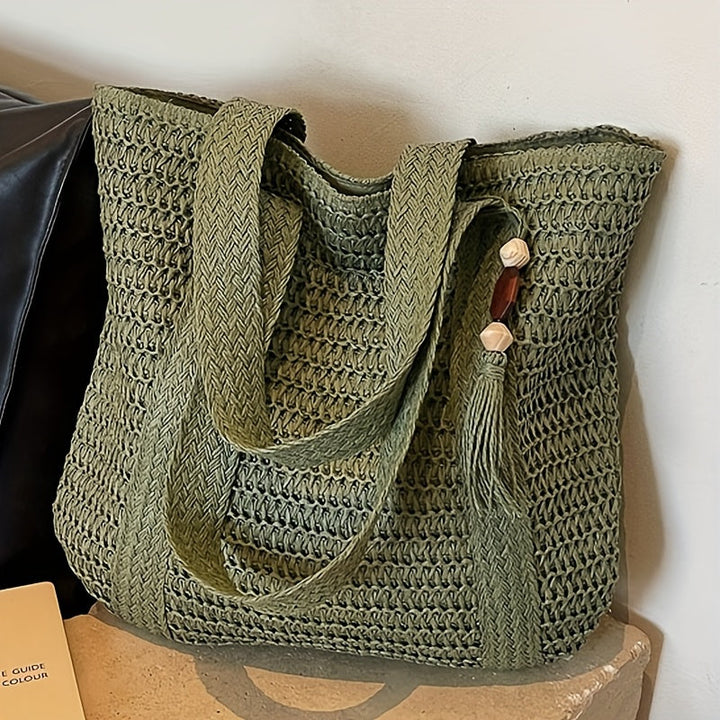 Boho-chic women's straw tote with dynamic fringe and a charming tassel. Perfect beach or holiday bag.