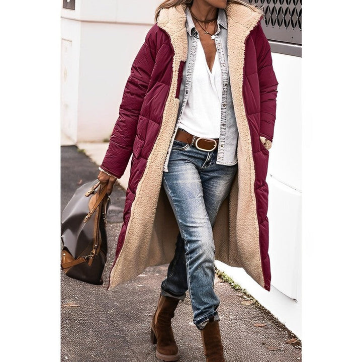 "Women's hooded longline quilted winter coat, front view; insulated, open front design with quilted texture and hood."