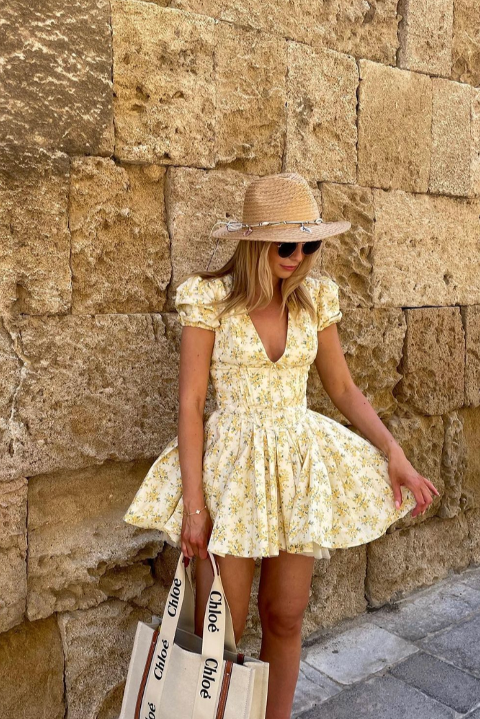 Versatile women's floral mini dress: yellow, puff sleeves, open back, A-line. Great for summer parties or casual.