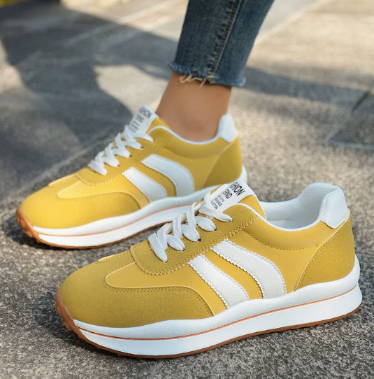 Yellow women's orthopedic sneakers with arch support for comfortable walking & athletic activities.