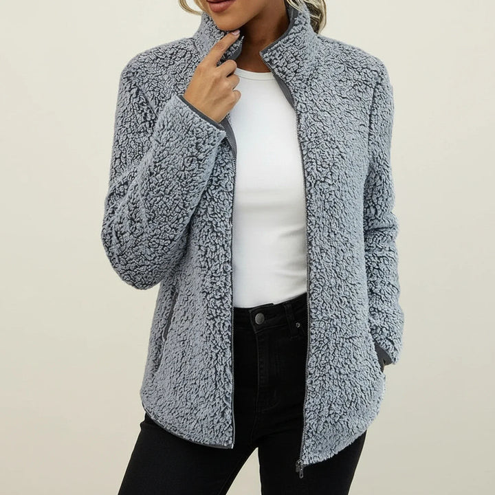 Stylish women's plush winter jacket, warm zip-up coat with a stand collar and relaxed fit for cozy casual wear.